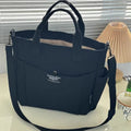 Khaki canvas tote bag with a solid-color exterior