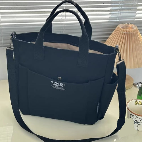 Khaki canvas tote bag with a solid-color exterior