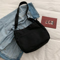 Large canvas shoulder bag with a long crossbody strap