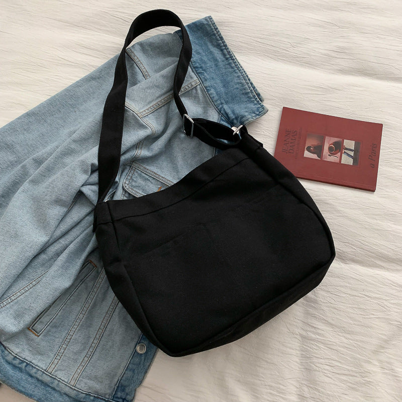 Large canvas shoulder bag with a long crossbody strap
