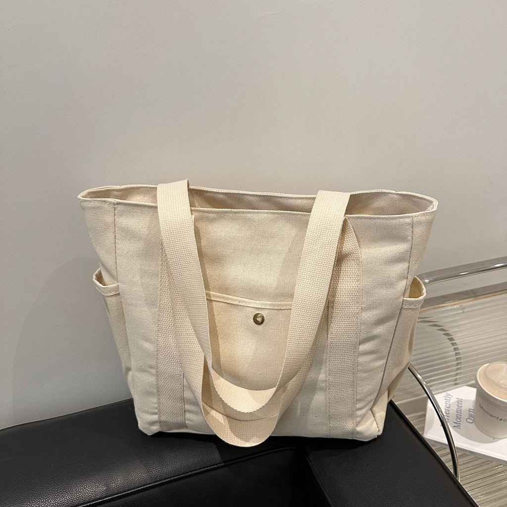 Spacious women's canvas tote bag for carrying college books and notebooks