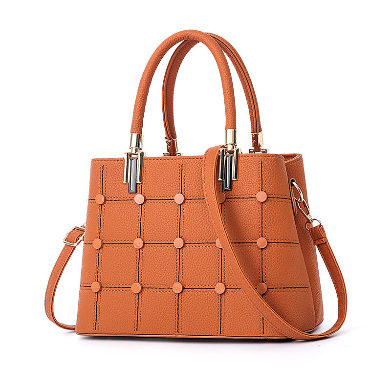 Studded women's fashion purse with a stylish leather-look finish