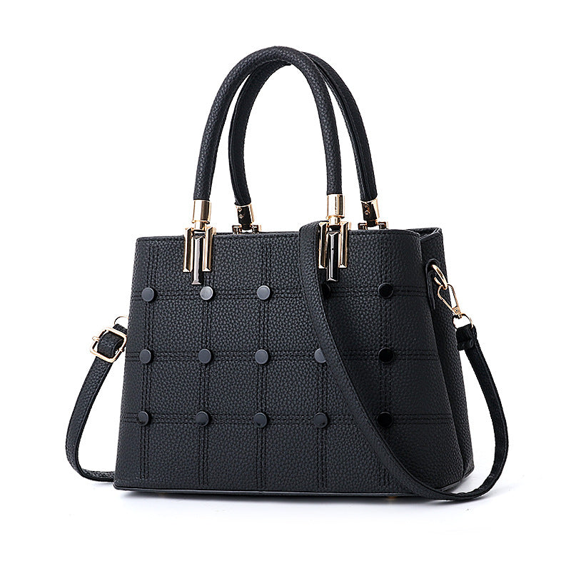 Women's PU leather handbag featuring decorative rivet details